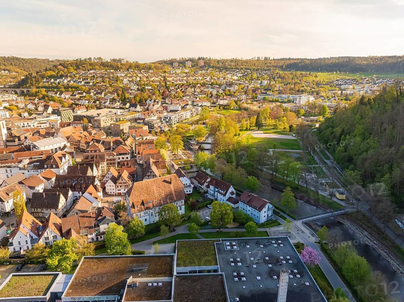 Urban landscape with river, numerous buildings and spacious green areas, Nagold, Black Forest, Germany