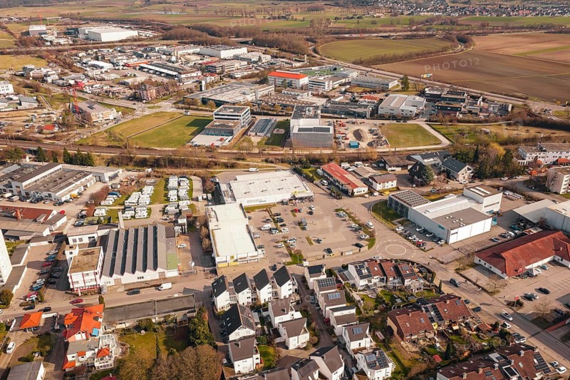 A view of an urban landscape with a central supermarket and industrial facilities, Gärtringen, Böblingen district, Germany