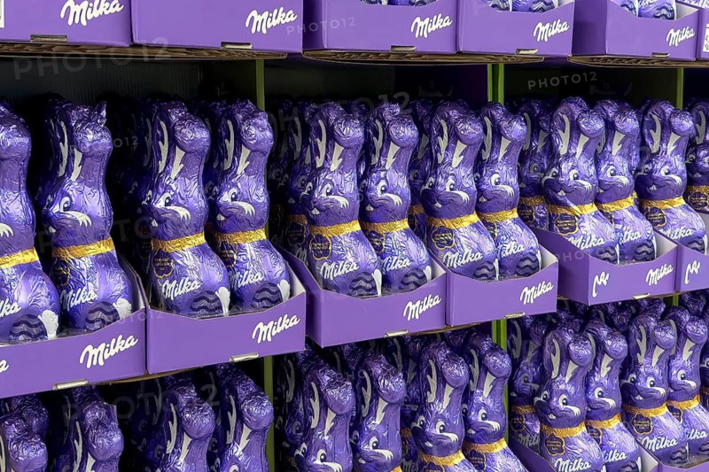 Display on the shelf of retail wholesale of chocolate Easter bunnies Easter bunnies Easter bunny brand Milka made of chocolate wrapped in purple purple tinfoil paper, Germany