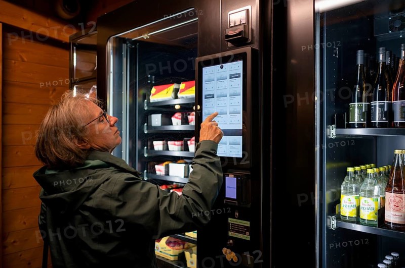 Elderly woman buying groceries at vending machine, display, food vending machine, farm shop, Stuttgart, Baden-Württemberg, Germany