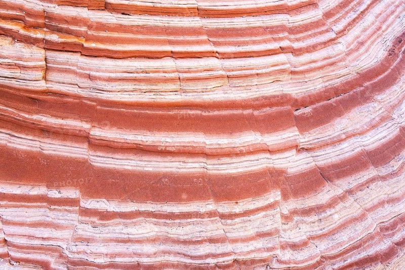 Detailed view of vibrant multilayered red rocks showcasing natural stratification and color variations