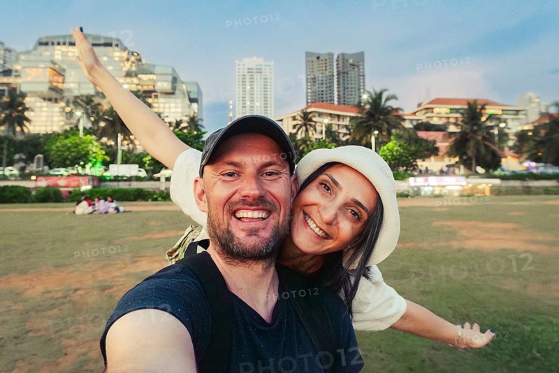 Cute happy caucasian couple enjoy travel freedom pose looking at camera explore Sri lanka city Colombo. Bonding and togetherness embracing time together