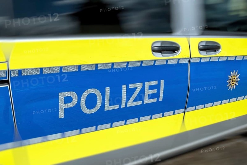Detailed view of a fast-passing emergency vehicle, police patrol car of the Baden-Württemberg police with motion blur