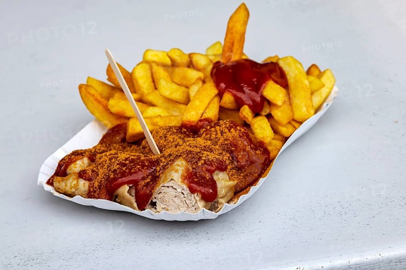 Cult in Berlin: Currywurst at Konnopke's Imbiss. Sausage with ketchup and french fries. Berlin, Germany