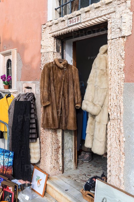 Fur coats hanging in a door for sale, Venice, Veneto, Italy