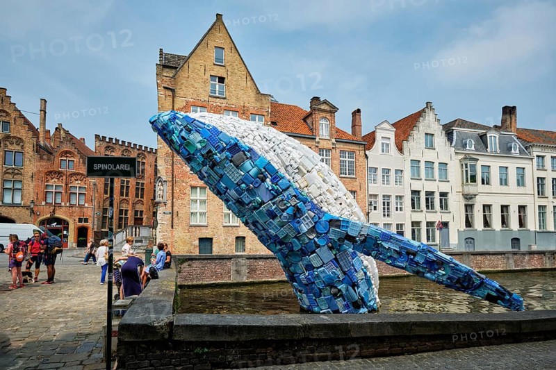 BRUGES, BELGIUM, MAY 29, 2018: Skyscraper or The Bruges Whale, whale rising up from the Canal installation made up of 5 tons of plastic waste pulled out of the ocean