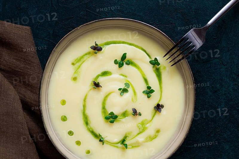Mashed potatoes, with green butter, micro greenery, homemade, on a dark background, no people, top view