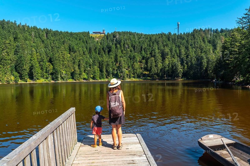 A family in summer at Lake Mummel or mummelsee, Black Forest, Germany