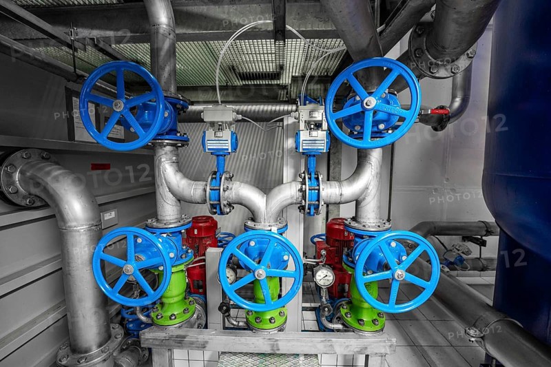 Complex arrangement of colourful valves and pipes in a technical room, ENCW Netze Calw waterworks, Calw, Black Forest, Germany