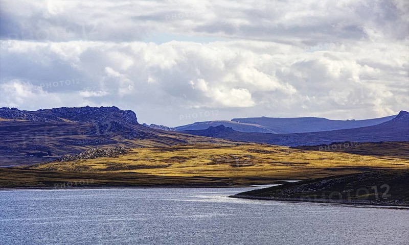 Playing light over mountains and water with dramatic clouds in the background, Stanley, East Falkland, Falkland Islands (UK), British Overseas Territory