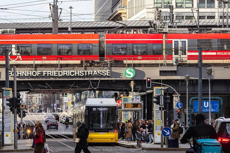 Street scene at Friedrichstraße Berlin station with road traffic. Regional train on the platform. Berlin, Germany