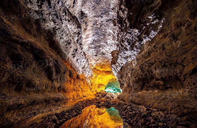 Lava tunnel, illuminated lava cave with perfect reflection in an underground lake, Cueva de los Verdes, Lanzarote, Canary Islands, Spain