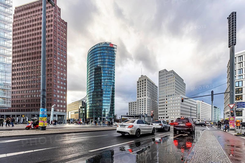 Potsdamer Platz Berlin in the evening with traffic on the streets. When it rains, the skyscrapers are reflected in puddles of water. Berlin, Germany