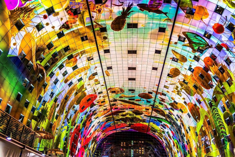 Markthal from 2014, offers over 100 food stalls and delicatessens with spectacular ceiling fresco cornucopia, Horn of Plenty by Arno Coenen and Iris Roskam, Rotterdam, the Netherlands