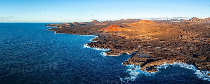 Coast with lava fields, volcanic landscape near Los Hervideros with red volcano Montaña Bermeja, in the evening light, aerial view, Lanzarote, Canary Islands, Spain
