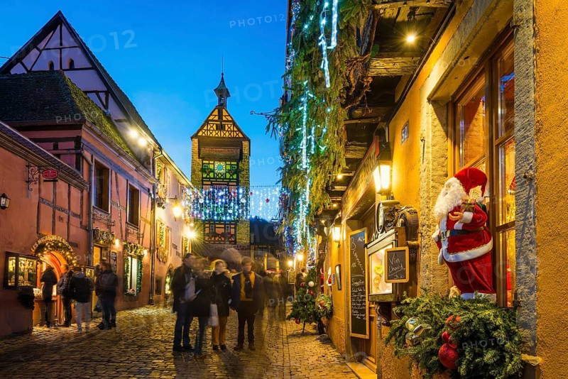 Colour-illuminated and Christmassy decorated half-timbered houses, blue hour, Christmas market, Riquewihr, Grand Est, Haut-Rhin, Alsace, France