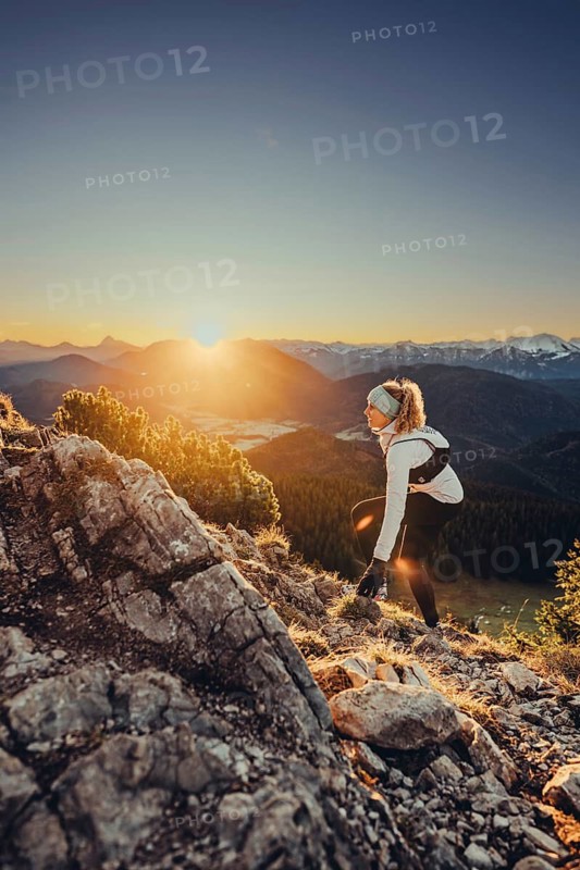 Trail running in autumn on the Jochberg on Lake Walchensee against the wonderful backdrop of the Alps, Bavaria, Germany