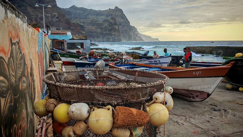 Fishing net and colorful boats on the coast with artistic walls, mural, graffiti and quiet evening mood at the fishing port, romantic, sunset, Ponta do Sol, Santo Antao, Cabo Verde, Cape Verde, Cape Verde