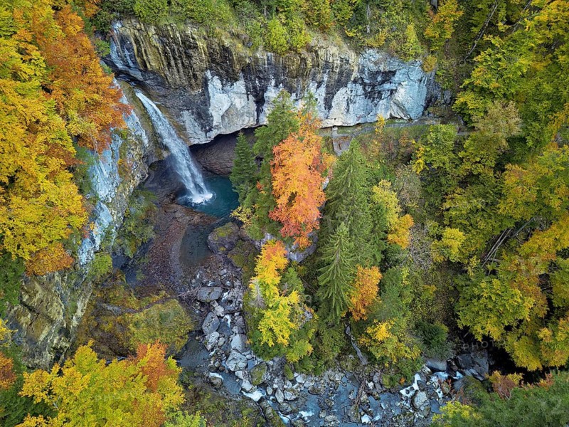 Aerial view of Berglistüber waterfall in autumn-colored surroundings, Linthal, Klausenpass, Canton of Glarus, Switzerland