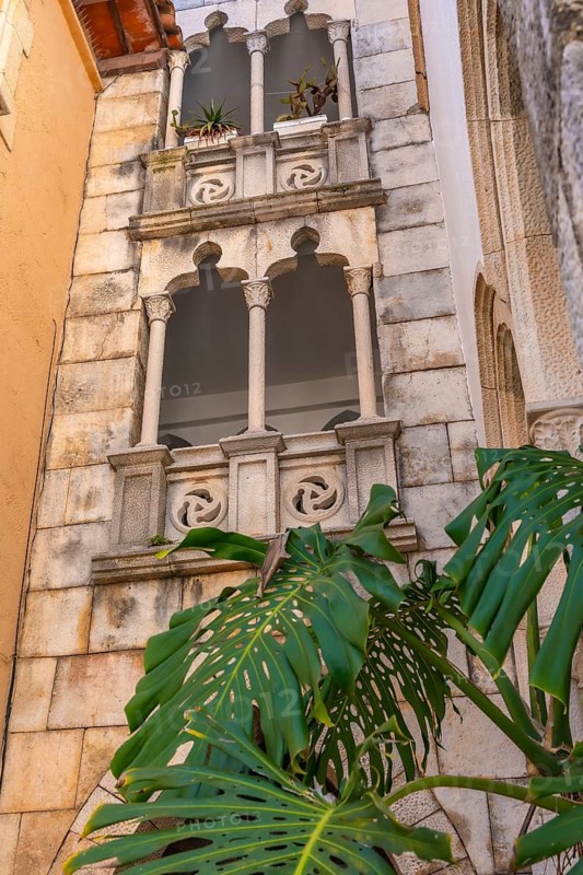 Decorative balcony with potted plants overlooking the mediterranean sea in roc de sant gaieta, a charming village near comarruga, tarragona, spain