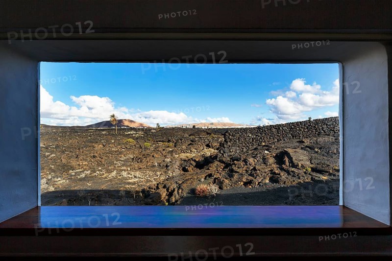 View from a window of lava field and volcanic cone, former residence of the artist, Fundacion Cesar Manrique, Tahiche, Teguise, Lanzarote, Spain