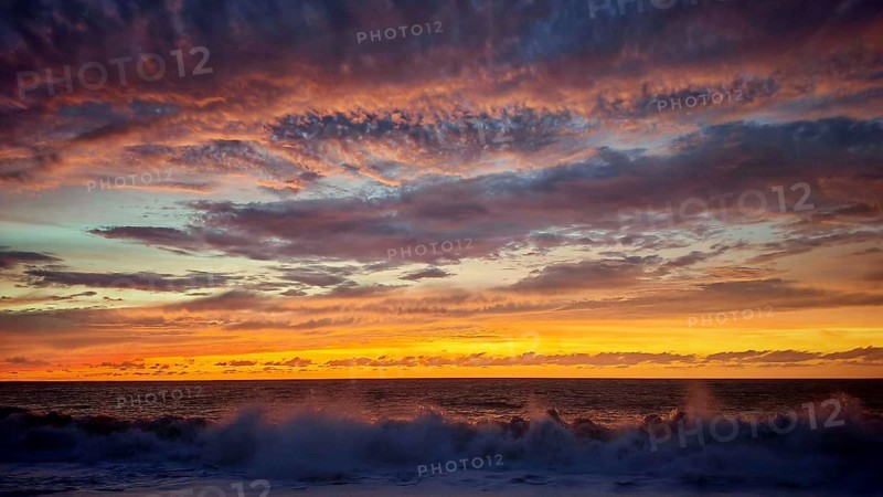 Dramatic sunset with powerful cloud formations and breaking waves in the foreground, Tarrafal de Monte Trigo, Santo Antao, Cabo Verde, Cape Verde