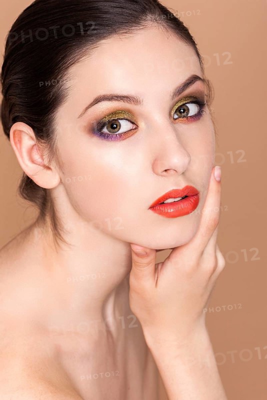 Beauty fashion girl. Portrait of beautiful young woman with fresh clean skin on baige background