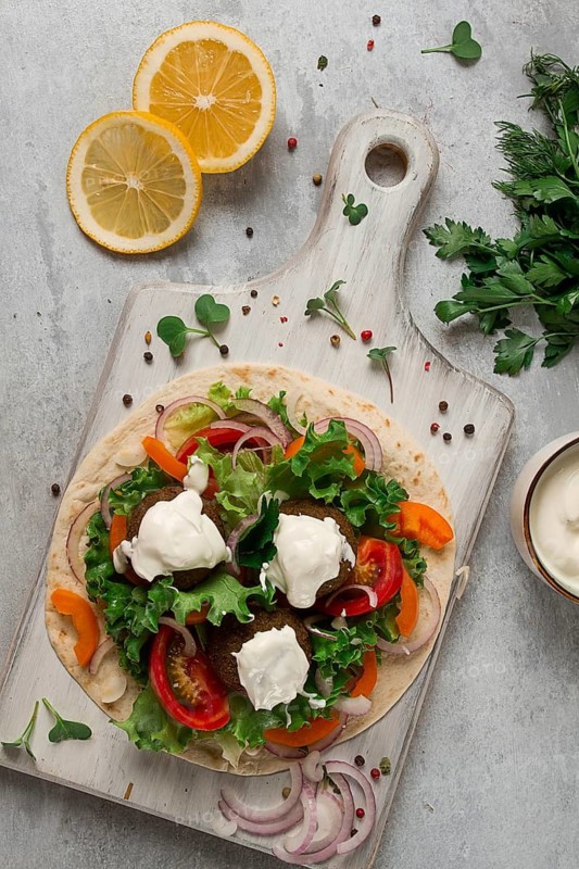 Tortilla with falafel and vegetable salad, white sauce, Arabic cuisine, top view, homemade, no people, vegetarian food
