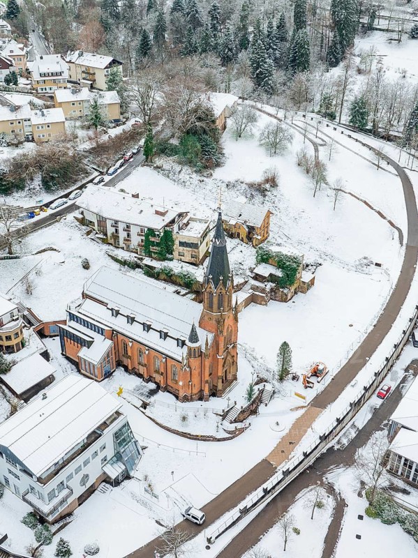 Aerial view of a snow-covered village with church and surrounding houses, St.Bonifatius, Catholic parish, Bad Wildbad, Black Forest, Germany