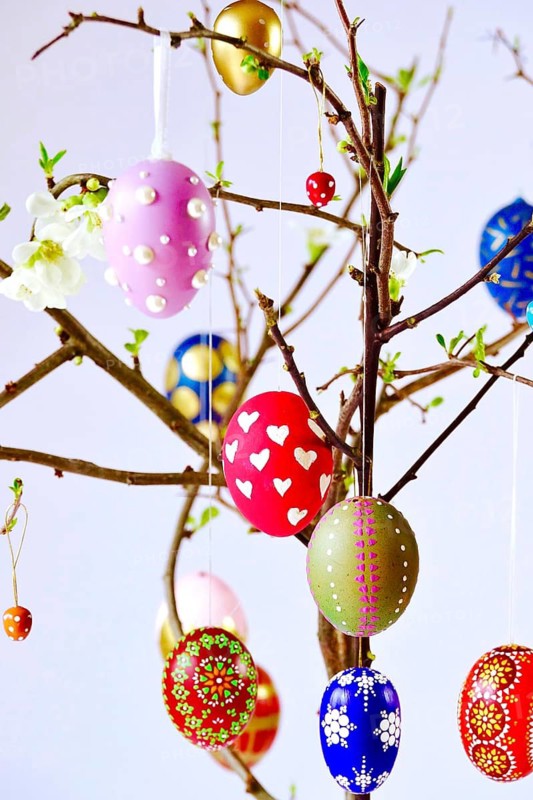 Easter, Easter bouquet with colorful Easter eggs, branches with flowers of an ornamental quince, spring, Germany