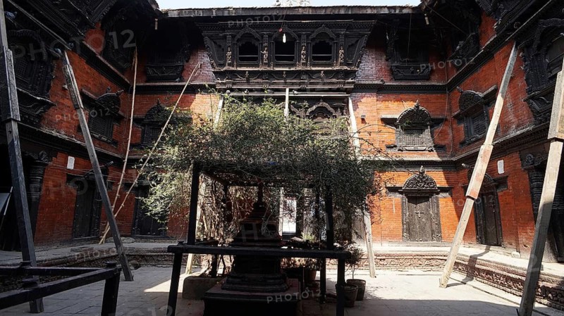 An intimate courtyard, Kumari Ghar at Durbarsquare in Kathmandu with detailed historic building facades and secured from collapse with wooden supports after the earthquake, Kathmandu, Nepal