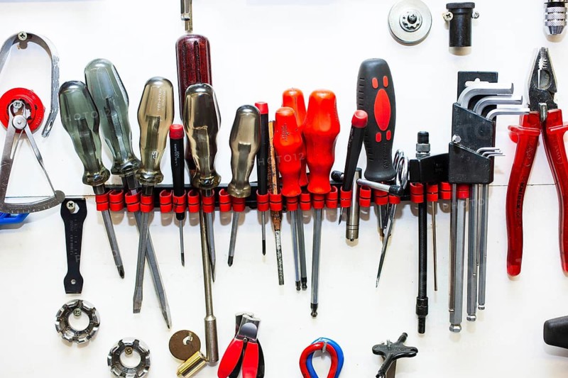 Various tools in a holder on a white wall, Düsseldorf, Germany
