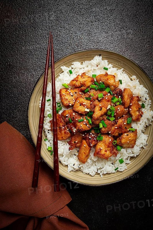 Fried chicken teriyaki with rice, green onion and sesame, homemade, no people