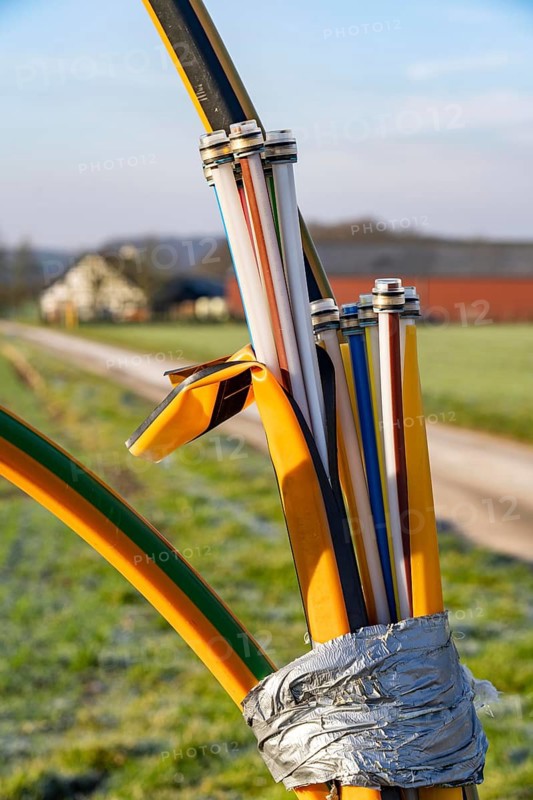 Fibre optic connection, empty conduits protrude from the ground along a dirt track, into which the actual fibre optic cable is later blown and connected to the respective house connection or distributor, provision of fast Internet in rural areas, in the south of Mülheim an der Ruhr, North Rhine-Westphalia, Germany