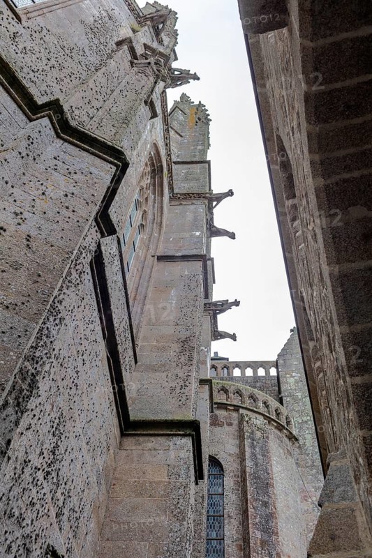 Gothic church walls and stone towers in impressive perspective, Le Mont-Saint-Michel