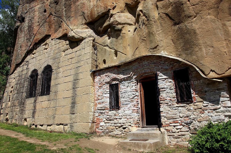 Corbii de Piatra rock monastery, stone ravens carved into a massive, 30-meter high sandstone wall, village of Jgheaburi, municipality of Corbi, in the district of Argesin, Wallachia, Romania