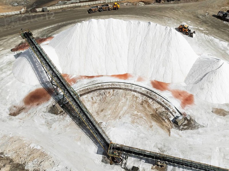 Conveyor belt and salt heaps at the Walvis Bay Salt works. Aerial view. Drone shot. Walvis Bay, Namibia