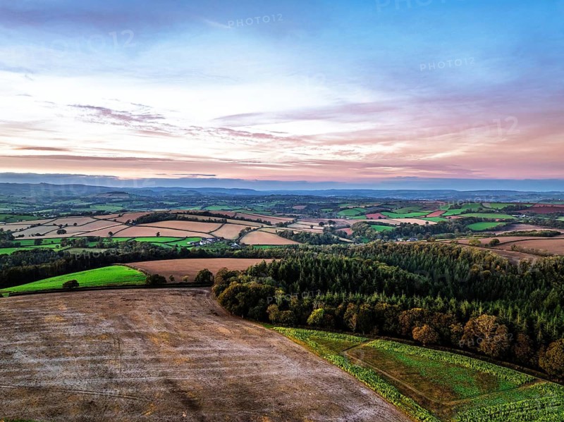 Sunset of Devon Farms and Fields over Berry Pomeroy from a drone, Totnes, England, United Kingdom