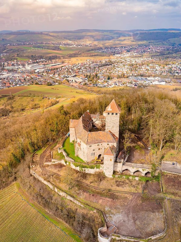Castle on a wooded hill with town in the background, autumn atmosphere, Lichtenberg Castle, Oberstenfeld, Germany