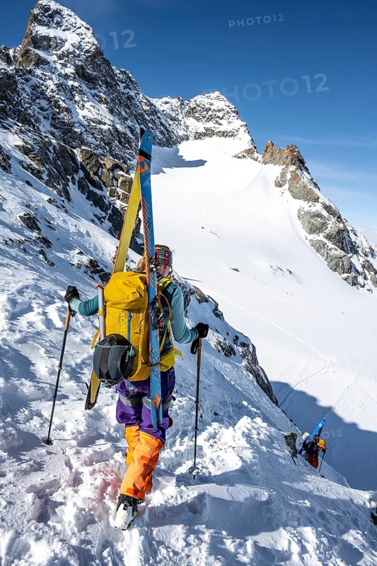 Mountaineer with skis at the fork Porta d'Es-cha, view of mountain peak Piz Kesch and glacier Vadret da Porchabella, ski tour Bündner Haute Route, Albula Alps, Rhaetian Alps, Grisons, Eastern Switzerland, Switzerland