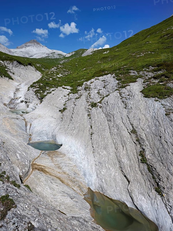 Glacier mill with glacier pots on the Trinser Alp Mora, Trin, Canton Graubünden, Switzerland