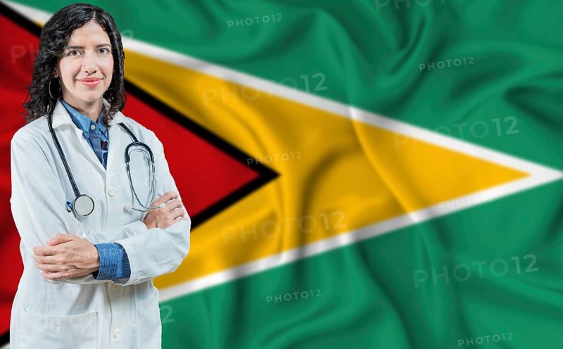 Guyanese medicine and healthcare concept. Doctor close up against Guyana flag background