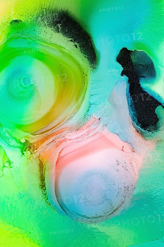 This image showcases an abstract composition with liquids patterns in vibrant green, pink, and blue hues. The swirling textures create a sense of movement in the galaxy