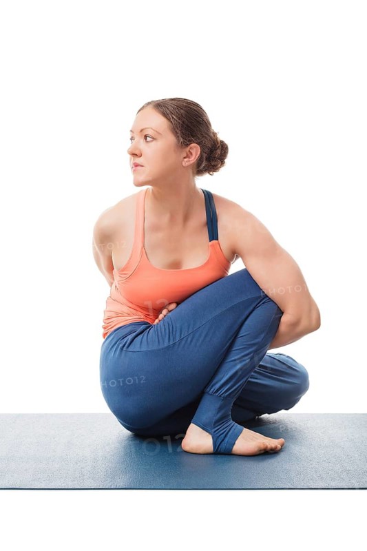 Woman doing Ashtanga Vinyasa Yoga stretching asana Marichyasana D, pose posture dedicated to sage Marichi on white background