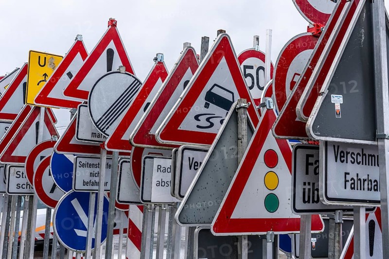 Storage for traffic signs in the yard of a road maintenance department, various signs with commandments and prohibitions, information about dangers, road traffic