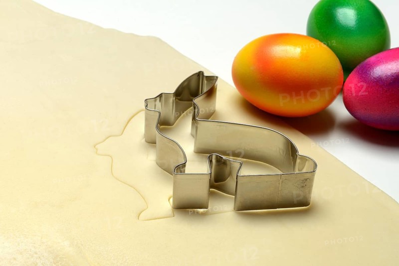 Rolled dough with bunny cookie cutter and easter eggs