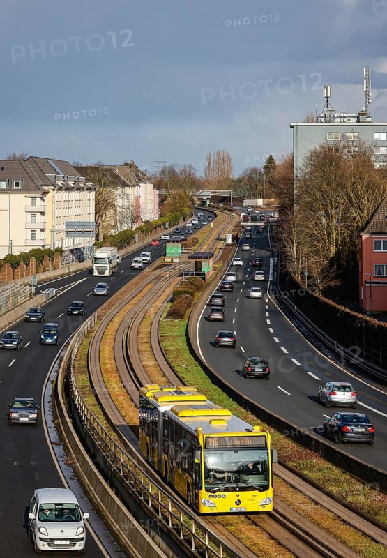 Essen, North Rhine-Westphalia, Germany - Cars and a public bus drive through Essen city centre on the A40 motorway
