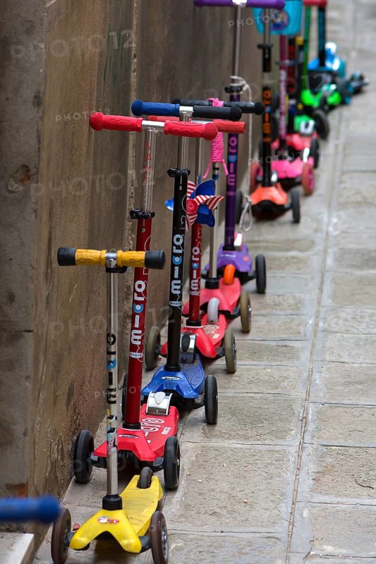 Parked children's scooters in front of a kindergarten, Venice, Veneto, Italy