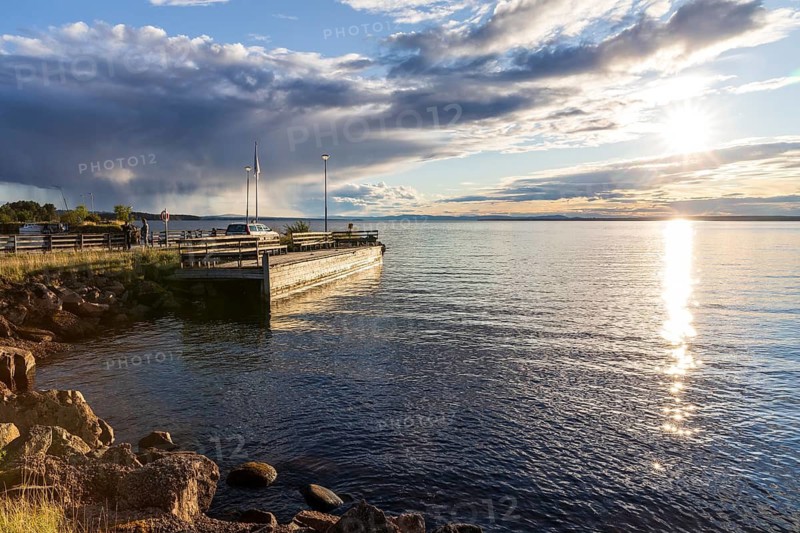 Evening with sun and clouds on Lake Siljan in Rättvik harbour, Dalarnas län, Sweden