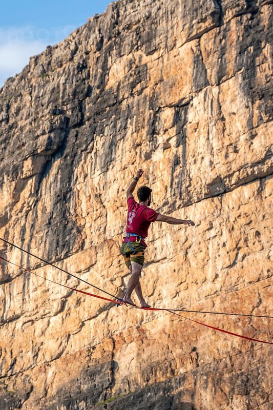 Slackliner in the mountains, mountain peaks of the Brenta Mountains, at Refugio Francis Fox Tuckett, Brenta, Brenta-Adamello Natural Park, Trentino, Italy